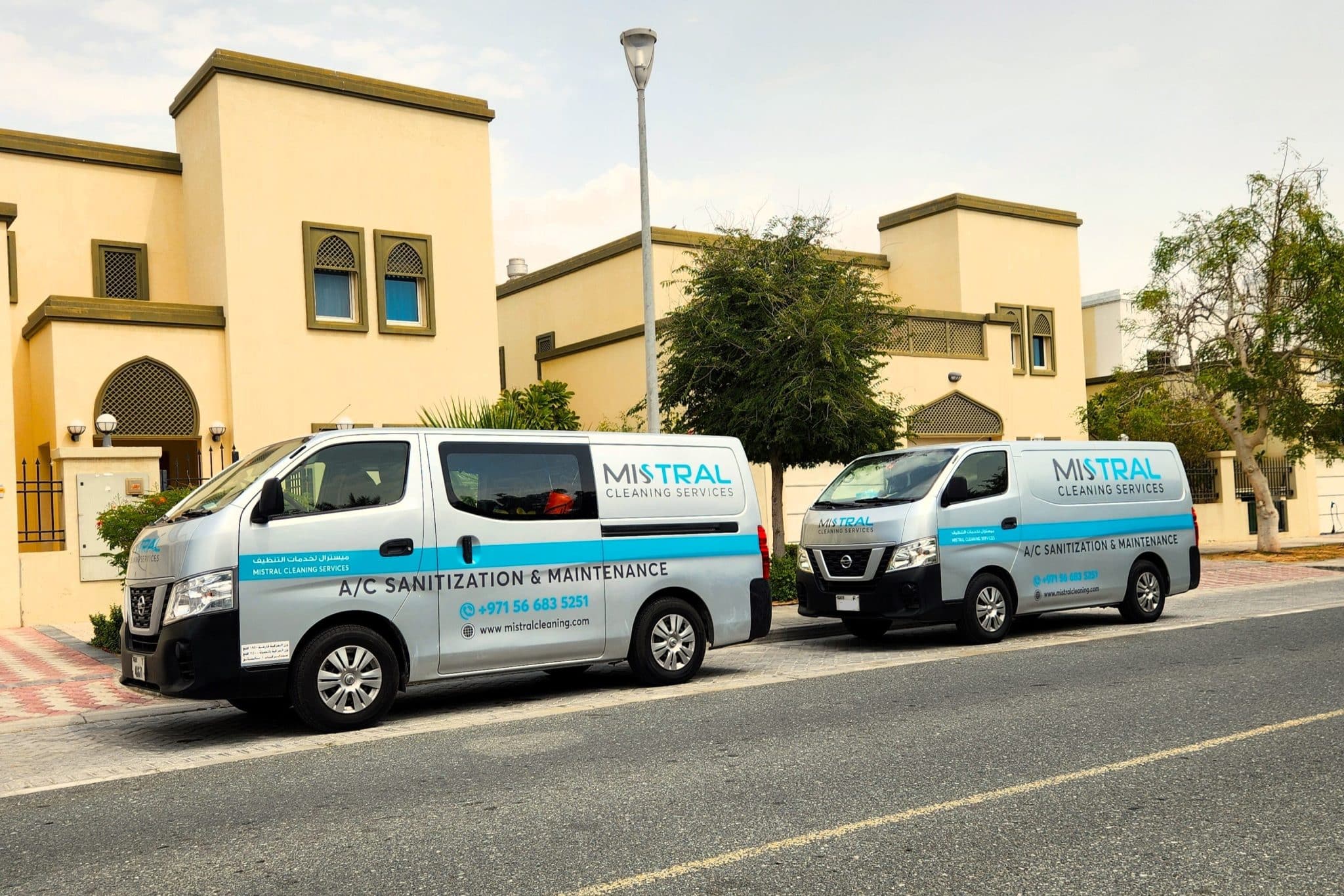 Two Mistral Cleaning vans parked in front a villa in Dubai