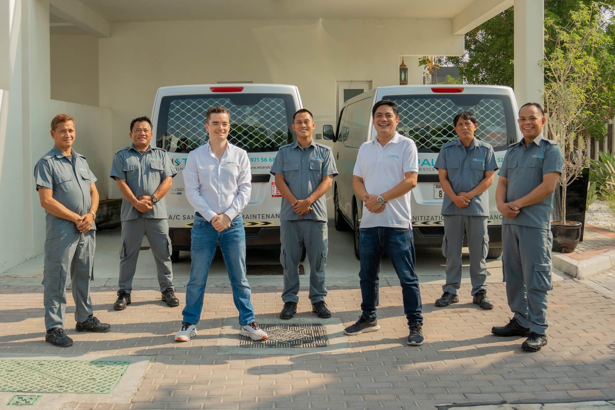 Technicians and Managers in front of Mistral Cleaning company vehicles