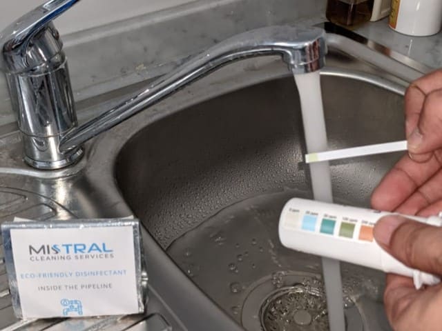 Technician performing a chlorine test on tap water during pipeline disinfection and flushing
