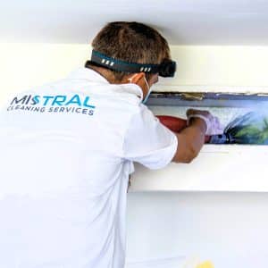 AC technician performing AC Duct Cleaning with the AC cleaning Rotobrush machine